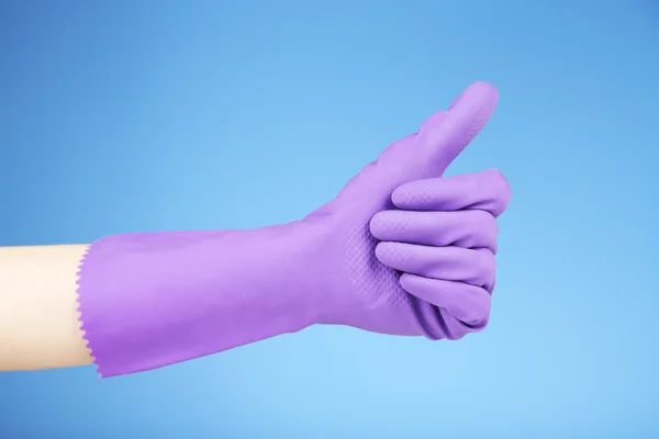 Rubber glove on hand, on blue background — Stock Photo, Image