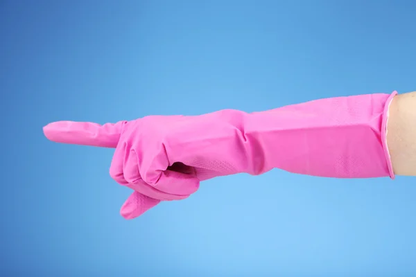 Rubber glove on hand, on blue background — Stock Photo, Image