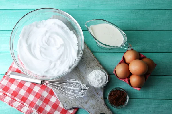 Whipped egg whites for cream on wooden table, top view — Stock Photo, Image
