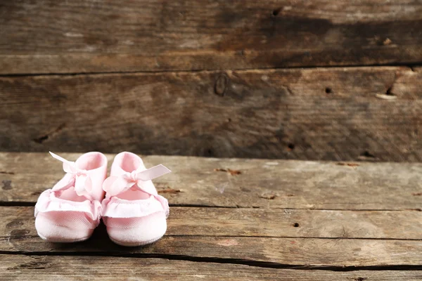 Pink toddler shoes on wooden background — Stock Photo, Image