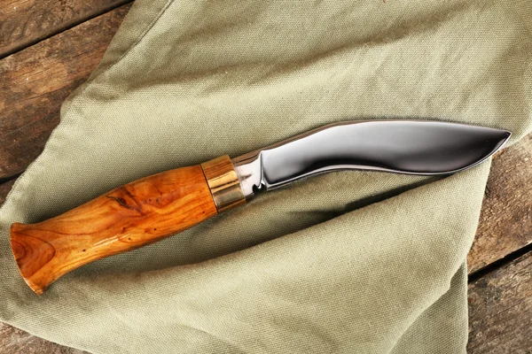 Coltello da caccia su tavola di legno con sacco, primo piano — Foto Stock