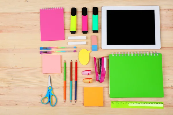 Digital tablet with stationery on wooden background — Stock Photo, Image