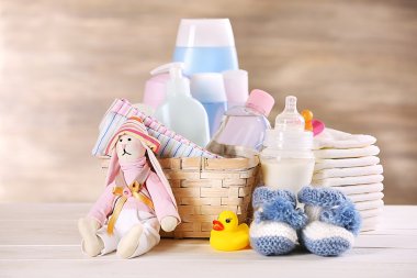 Baby accessories on table on grey background clipart