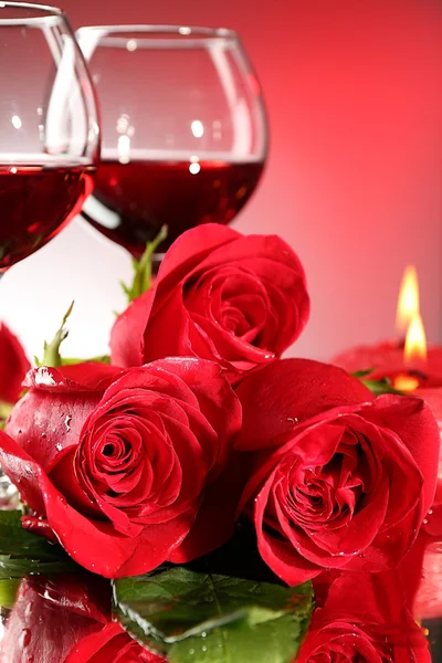 Composition with red wine in glasses, red rose and decorative heart on colorful background — Stock Photo, Image