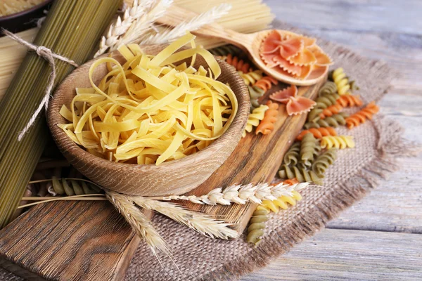 Different types of pasta on sackcloth — Stock Photo, Image