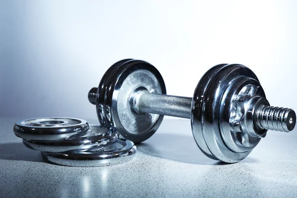 Dumbbells on gray background — Stock Photo, Image