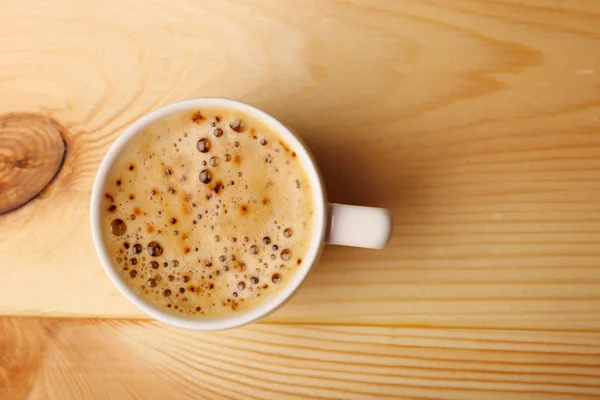 Cup of coffee on wooden table — Stock Photo, Image