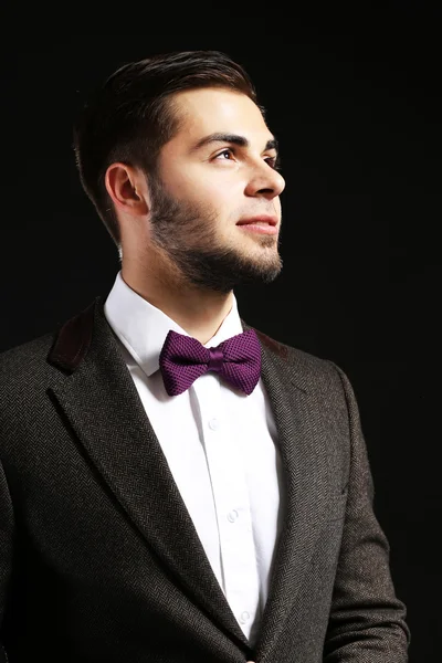 Elegant man in suit on dark background — Stock Photo, Image