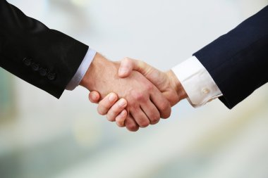 Parlak arkaplanda iş tokalaşması