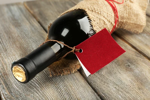 Bottle wrapped in burlap cloth — Stock Photo, Image