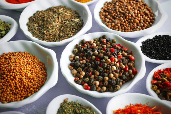 Different kinds of spices in ceramics spoons — Stock Photo, Image