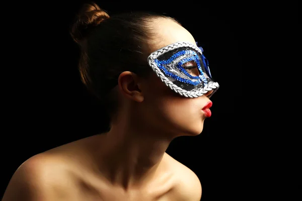 Portrait of beautiful woman with fancy glitter makeup and Masquerade mask on dark background — Stock Photo, Image