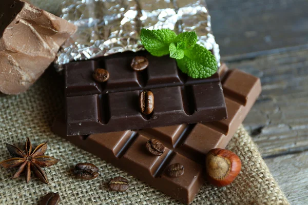 Вкусный шоколад со специями на деревянном столе, крупным планом — стоковое фото