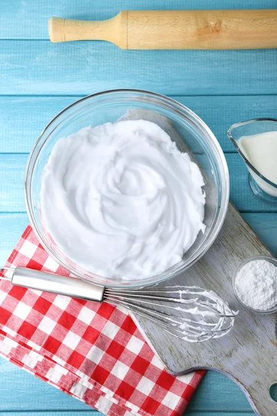 Schlageiweiß für Sahne auf Holztisch, Ansicht von oben — Stockfoto