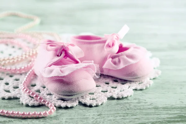 Cute toddler shoes on wooden background — Stok fotoğraf