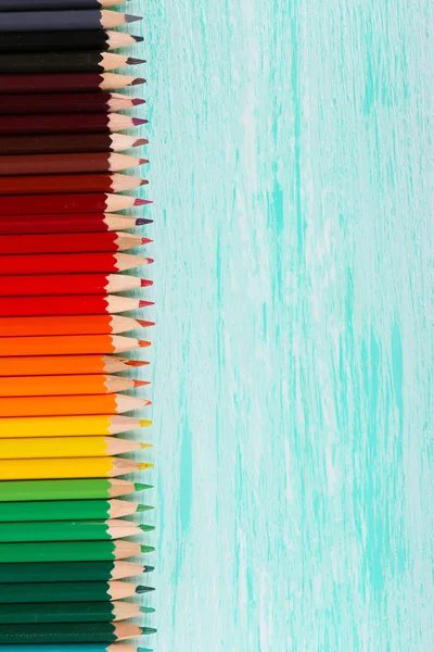 Colorful pencils on wooden table — Stock Photo, Image
