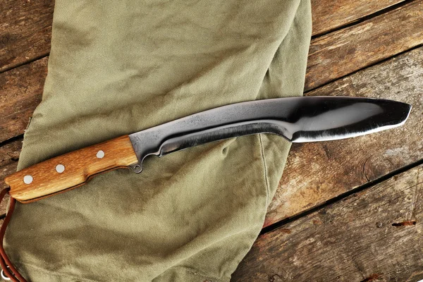 Hunting knife on wooden table with sackcloth, closeup — Stock Photo, Image