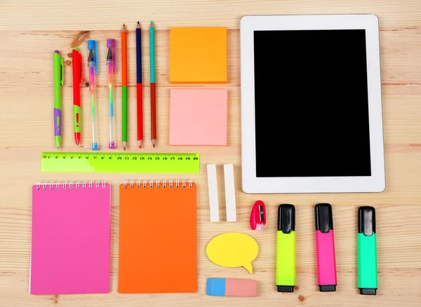 Digital tablet with stationery on wooden background — Stock Photo, Image