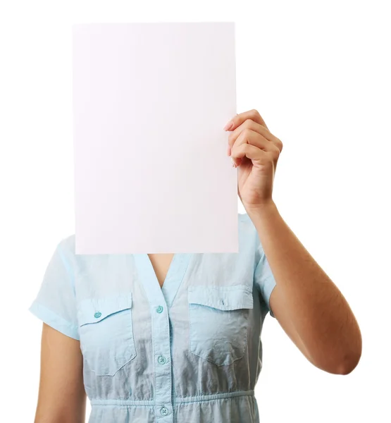 Woman covering her face with blank sheet of paper isolated on white