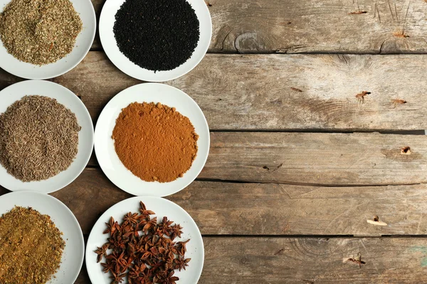 Different spices on plates — Stock Photo, Image