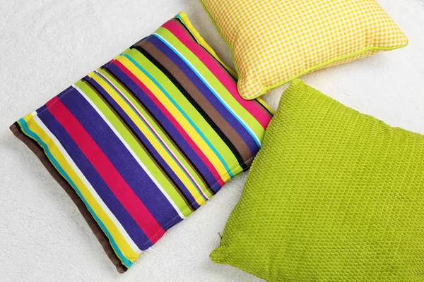Decorative pillows on plaid — Stock Photo, Image