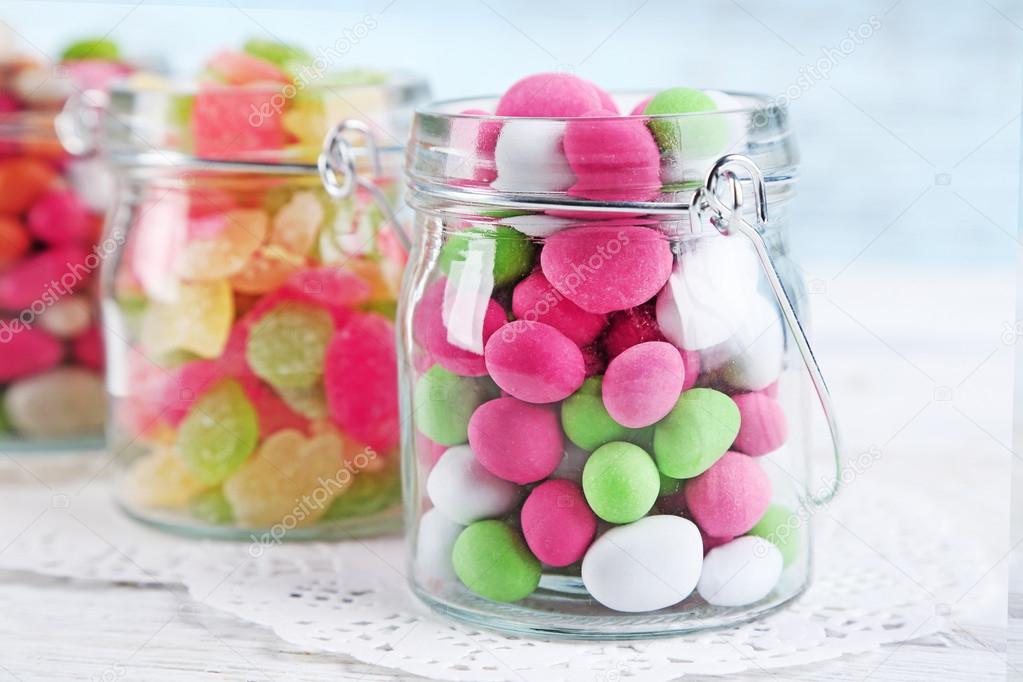 Multicolor candies in glass jars — Stock Photo © belchonock 69727379