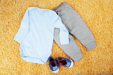 renkli arka plan üzerinde erkek bebek için giyim