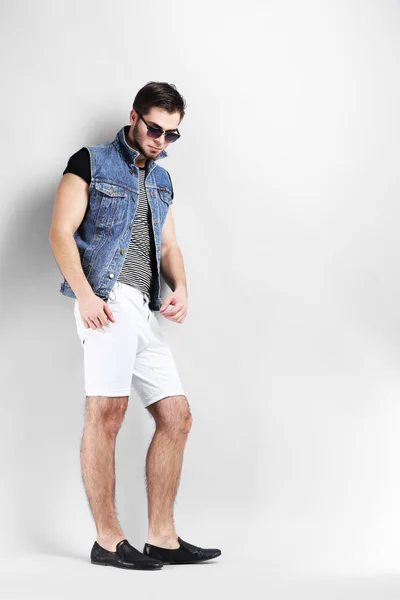 Man in white shorts and jeans vest — Stock Photo, Image