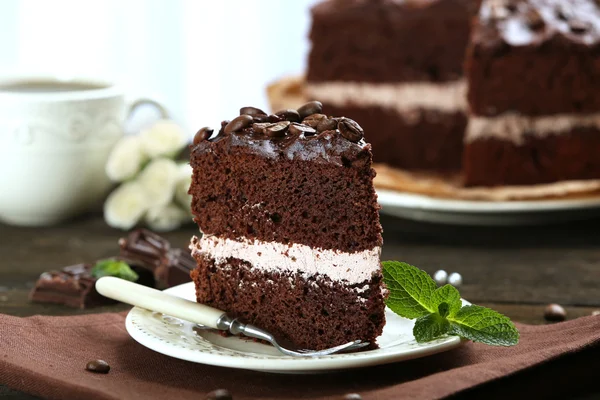 Delicious chocolate cake on table on light background — Stock Photo, Image