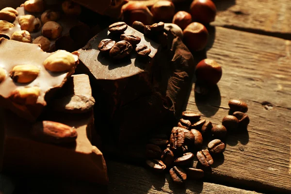 Still life with set of chocolate with nuts on wooden table, closeup — Stock Photo, Image