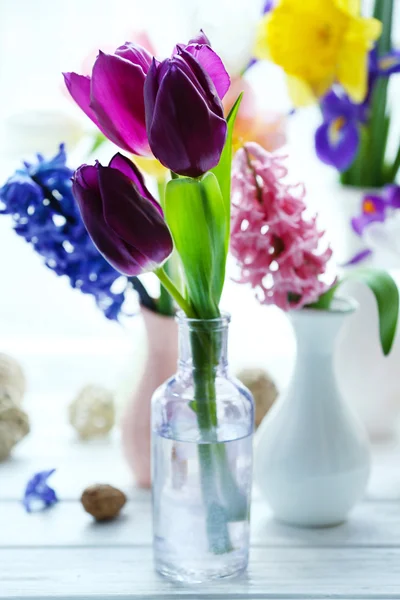 Beautiful bouquets of spring flowers on windowsill background — Stock Photo, Image