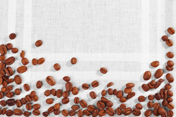 Frame of coffee beans on color sackcloth background — Stock Photo, Image
