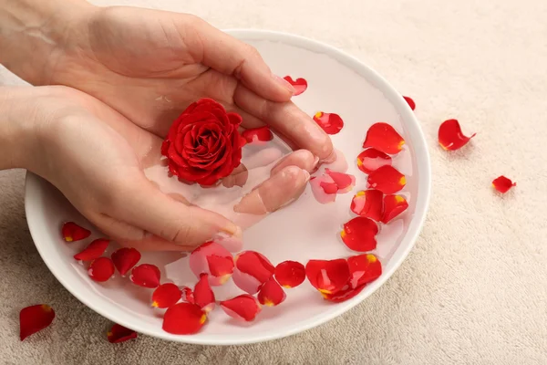 Female hands with bowl of aroma spa water on table, closeup — Stock Photo, Image