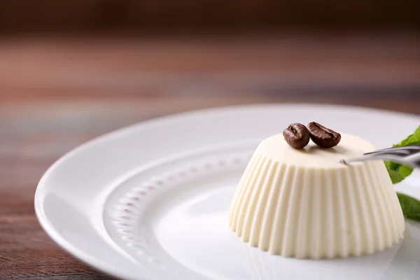 Tasty panna cotta dessert on plate, close up — Stock Photo, Image