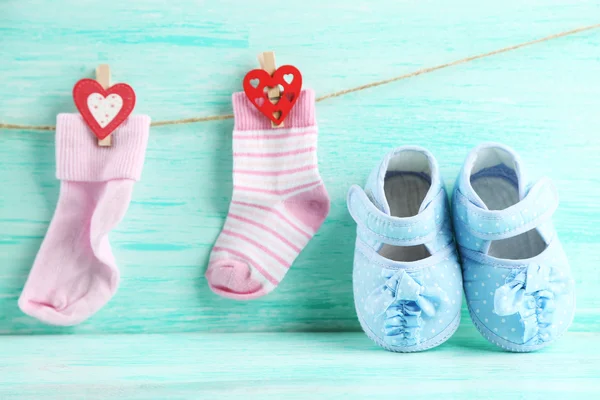 Cute toddler shoes on wooden background