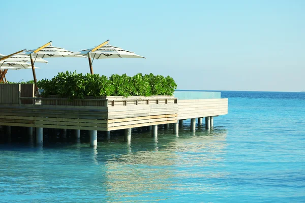 Restaurant in ocean on blue sky background — Stock Photo, Image