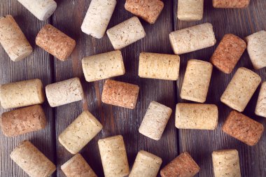 Wine corks on rustic wooden planks background clipart
