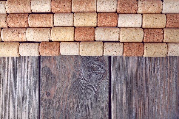 Wine corks on rustic wooden planks background