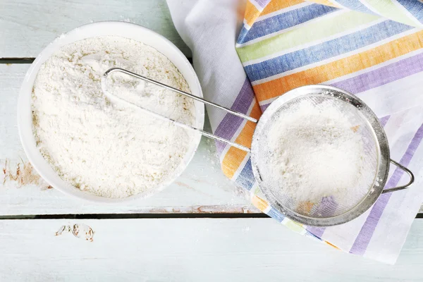 Sifting flour through sieve on wooden table, top view — Stock Photo, Image