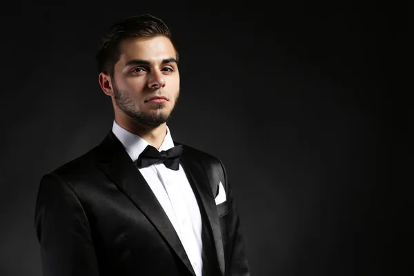 Elegant man in suit on dark background — Stock Photo, Image