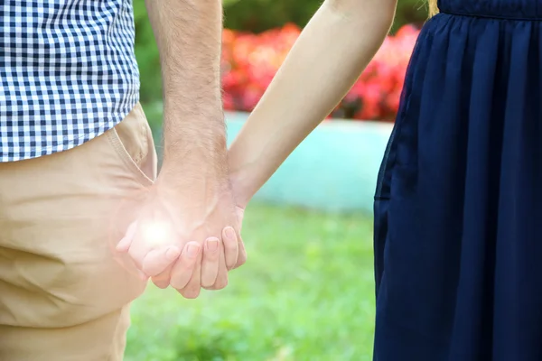 Loving couple holding hands outdoors — Stock Photo, Image