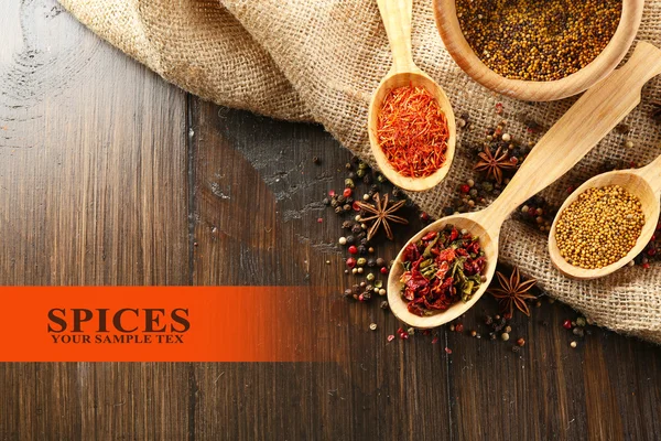 Different kinds of spices on wooden background — Stock Photo, Image