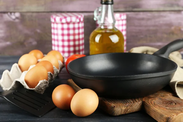 Still life with eggs and pan — Stock Photo, Image