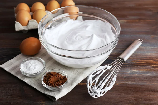 Whipped egg whites for cream on wooden background — Stock Photo, Image