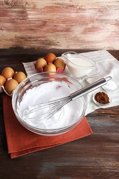 Whipped egg whites and other ingredients for cream on wooden table, closeup — Stock Photo, Image