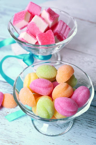 Sweet candies on color wooden table, closeup — Stock Photo, Image