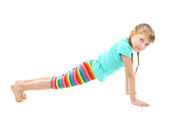 Little girl doing exercises isolated on white — Stock Photo, Image