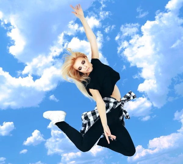 Jumping woman on sky background — Stock Photo, Image