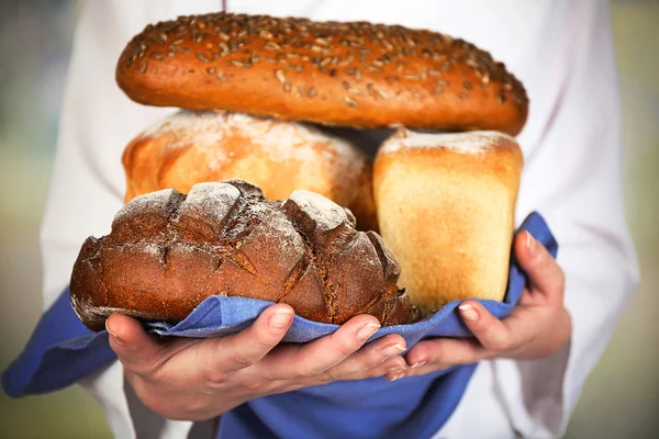 Armful of freshly bread in female hands — Stock Photo, Image