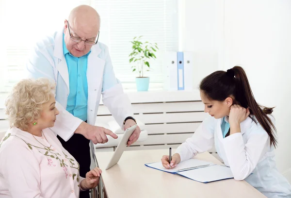 Happy doctors and patient in hospital clinic — Stock Photo, Image